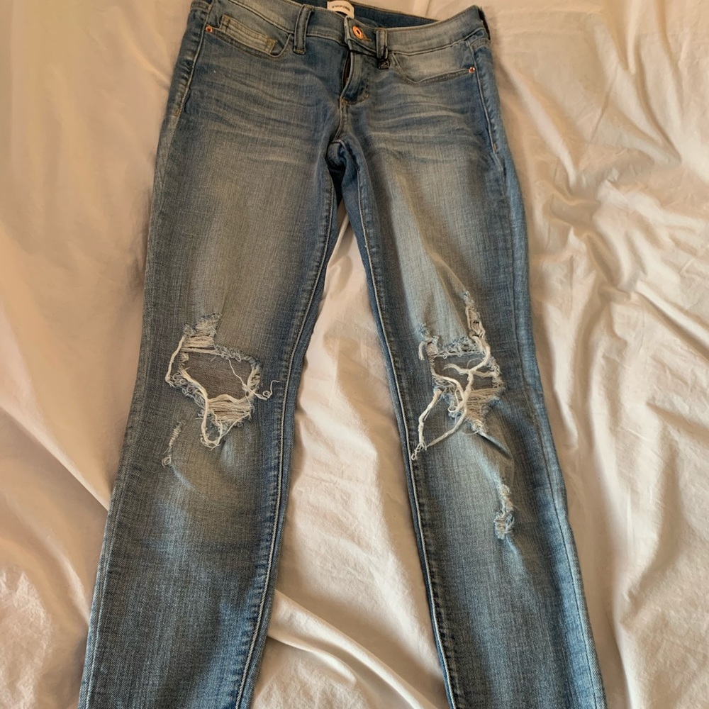 Light wash destructed knee frayed hem denim